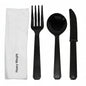 Black plastic fork, spoon, and knife set with a white napkin on a white background