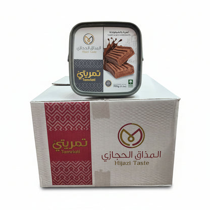 Tin of cookies with a box labeled 'Hijazi Taste' on a busy market shelf.