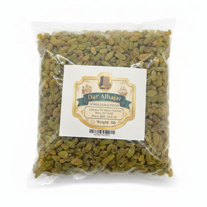 Packaged green raisins with a label on a white surface