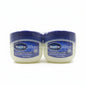Two containers of Vaseline lip balm in a store setting