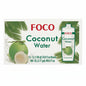 A 12-count box of FOCO Coconut Water displayed on a store shelf, with other grocery boxes in the blurred background.